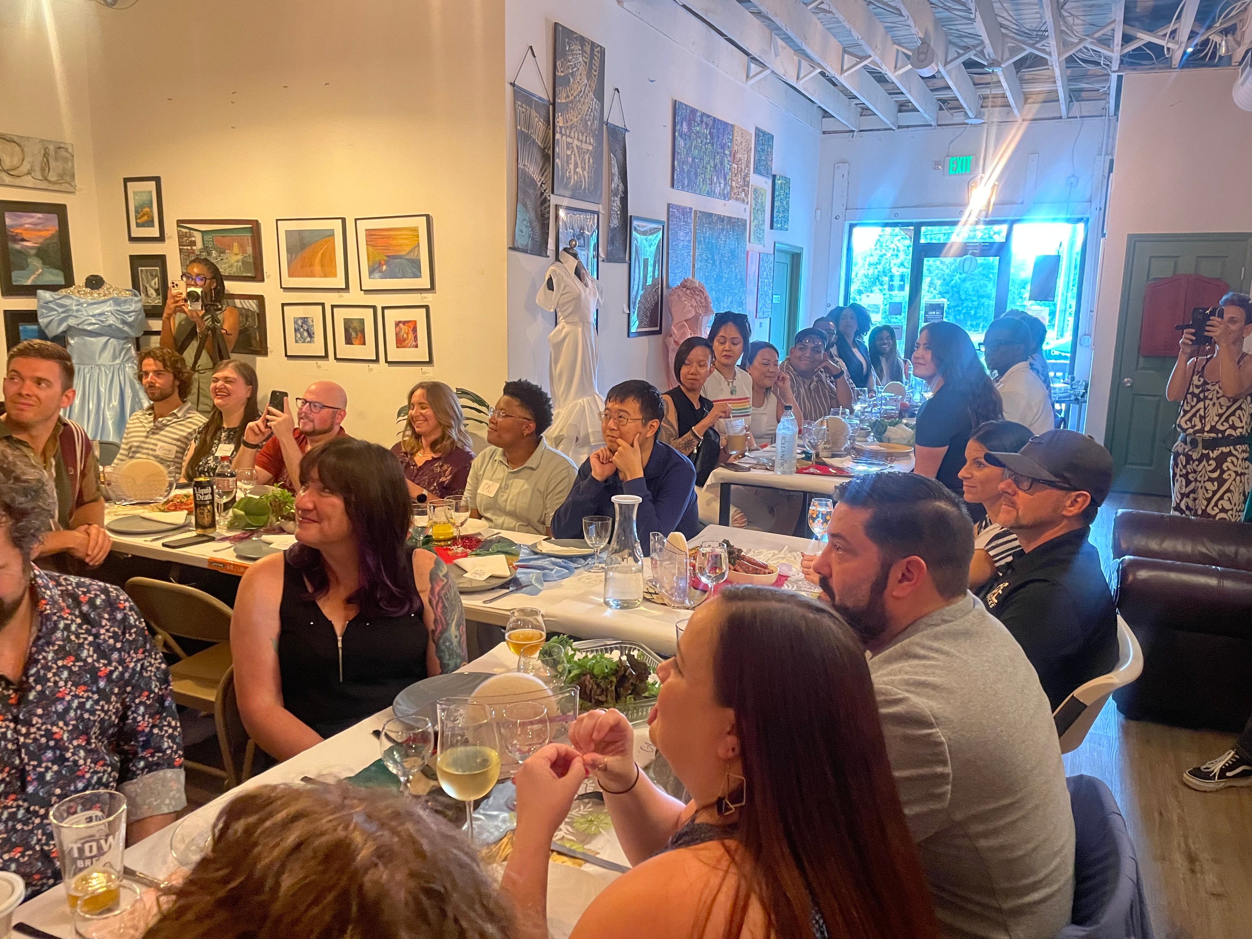 Friends gathering around the table to enjoy a family style meal